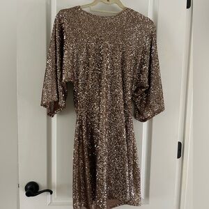 Gold sequin dress with draped back.